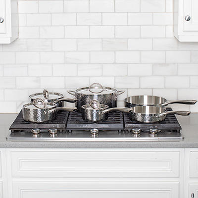 BERGHOFF<sup>&reg;</sup> 10 Piece Cookware Set - This beautiful hammered stainless steel cookware set is sure to be the focal point of your kitchen. Set includes: 1 Qt, 2 Qt and 3 Qt sauce pans with lids, 5.75 Qt Dutch oven with lid, 8in deep skillet/fry pan and 9.5in deep skillet/ fry pan. Large easy to hold handles. Not for use on induction cooktops.